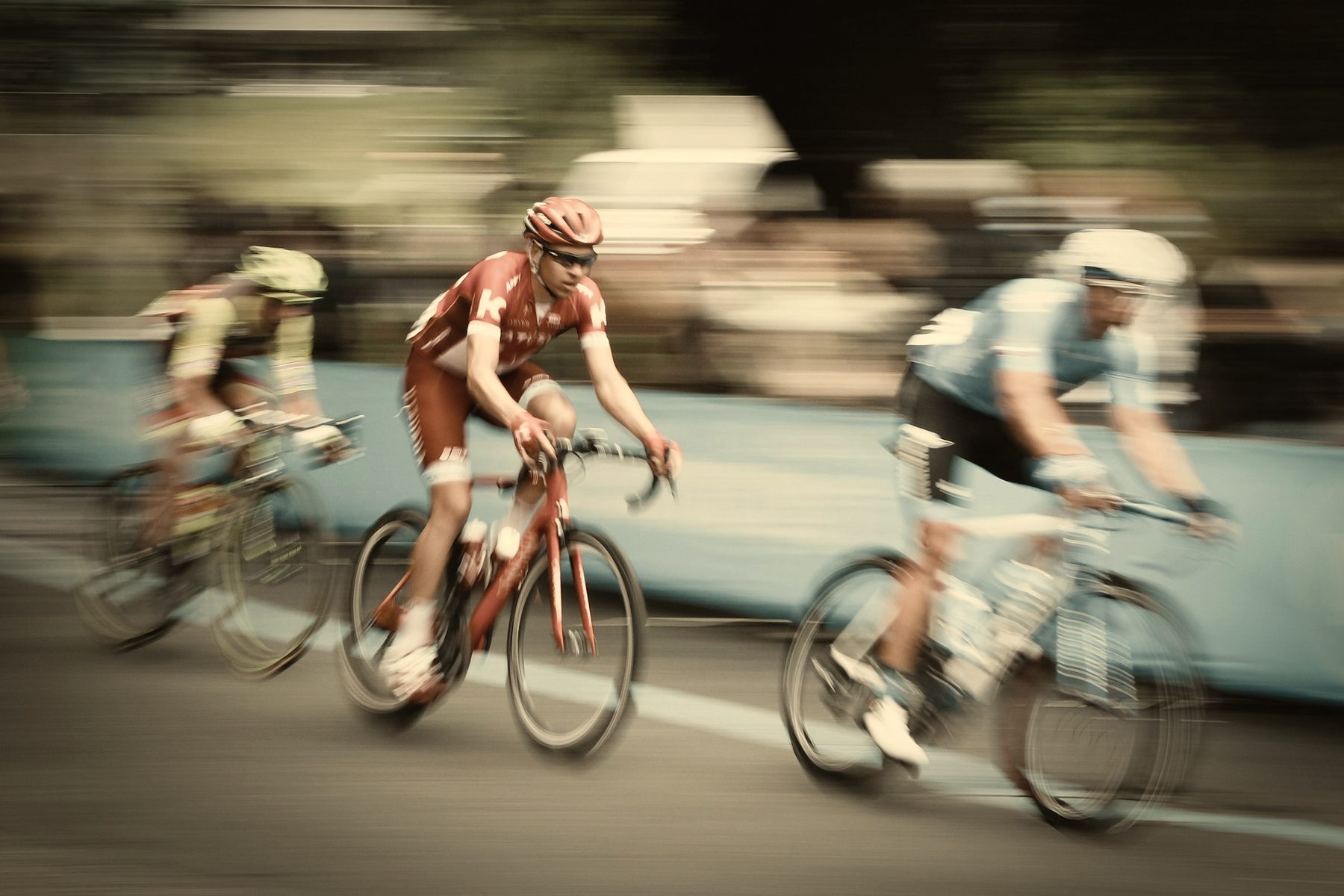 Cyclists riding in a warm-lit road pack